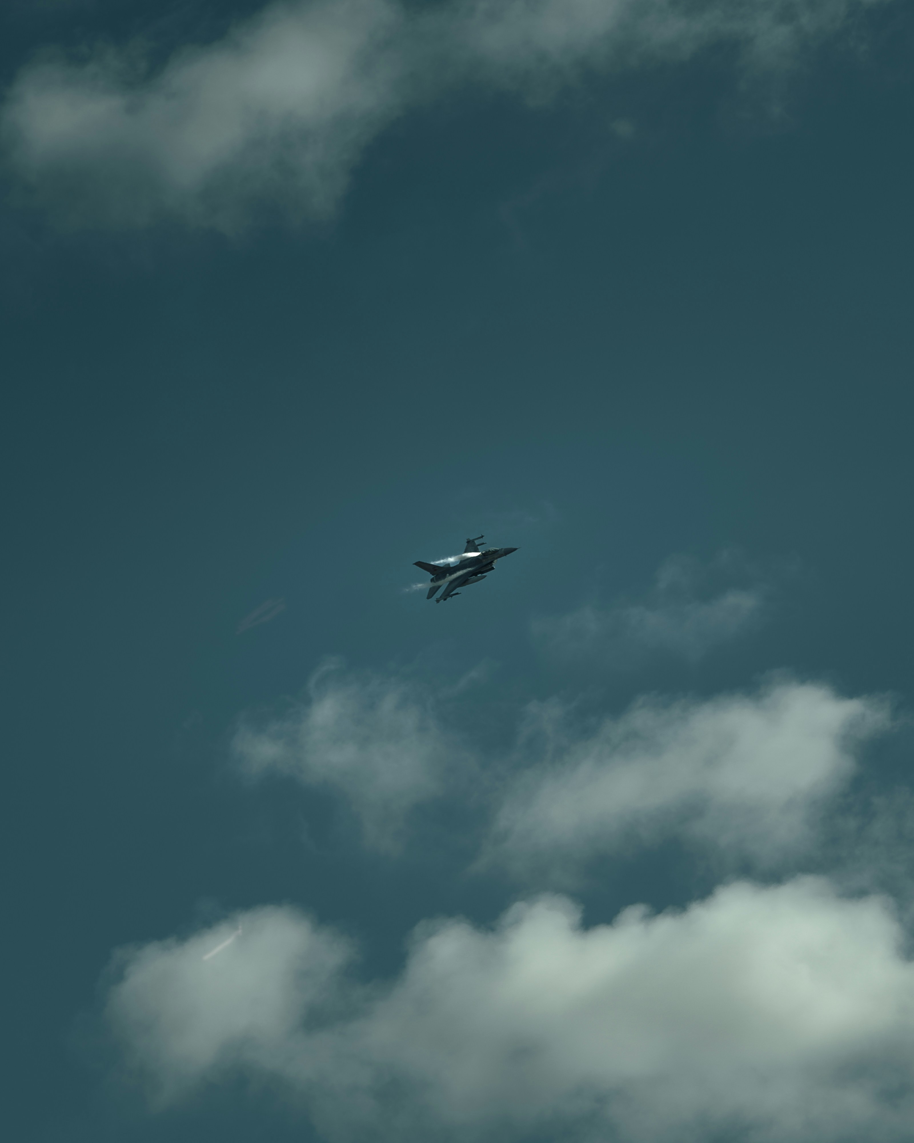 An airplane is flying through the cloudy sky