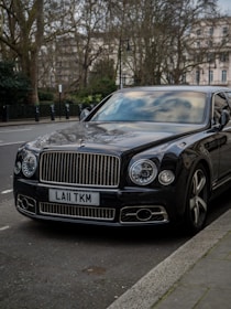 A black car parked on the side of the road