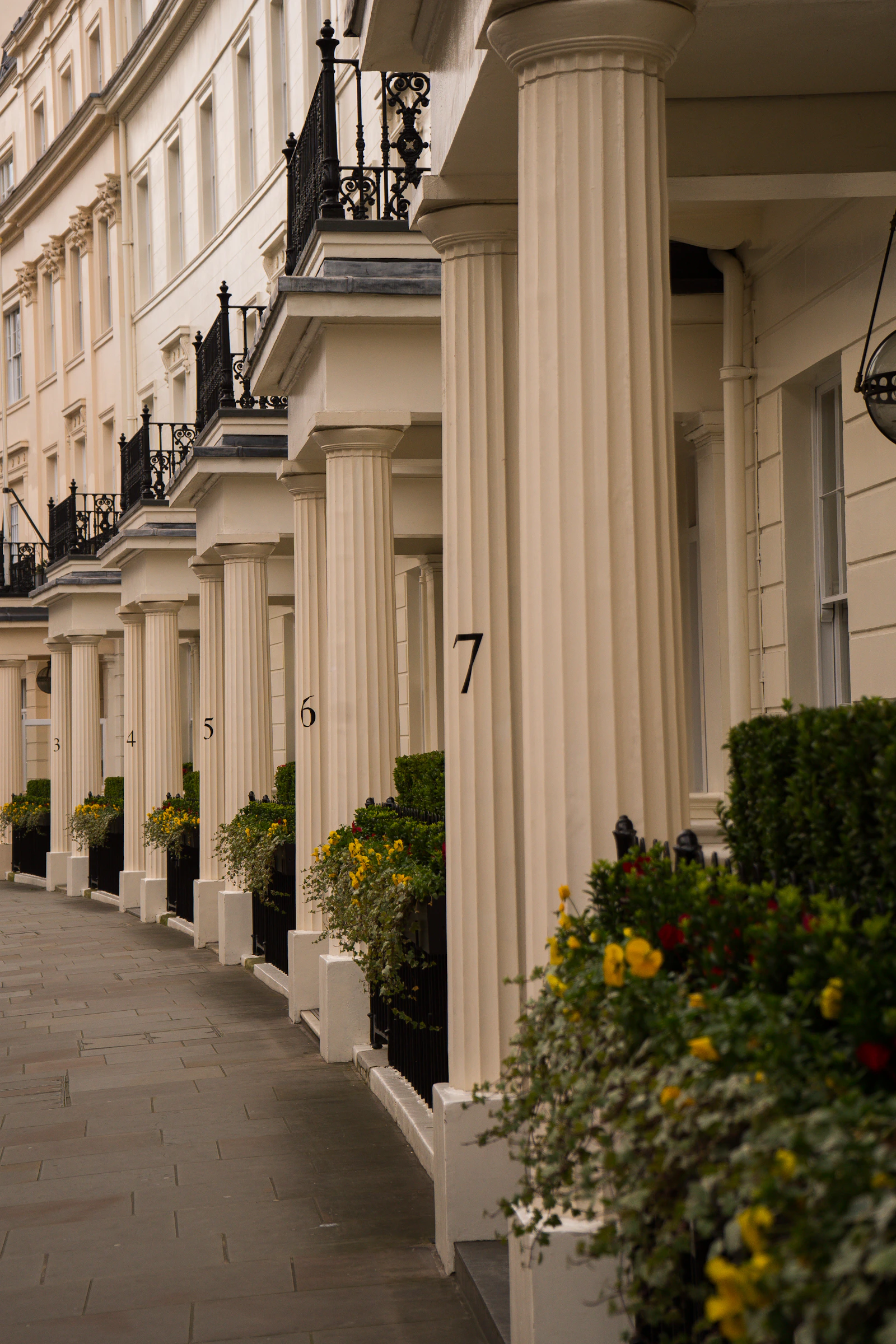 Cream stucco townhouses with classical porticos on a London street