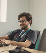 A man sitting in front of a laptop computer