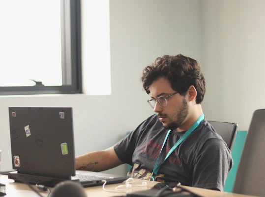 A man sitting in front of a laptop computer