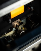 A close up of a machine with a yellow label on it