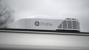 A projector sitting on top of a window sill