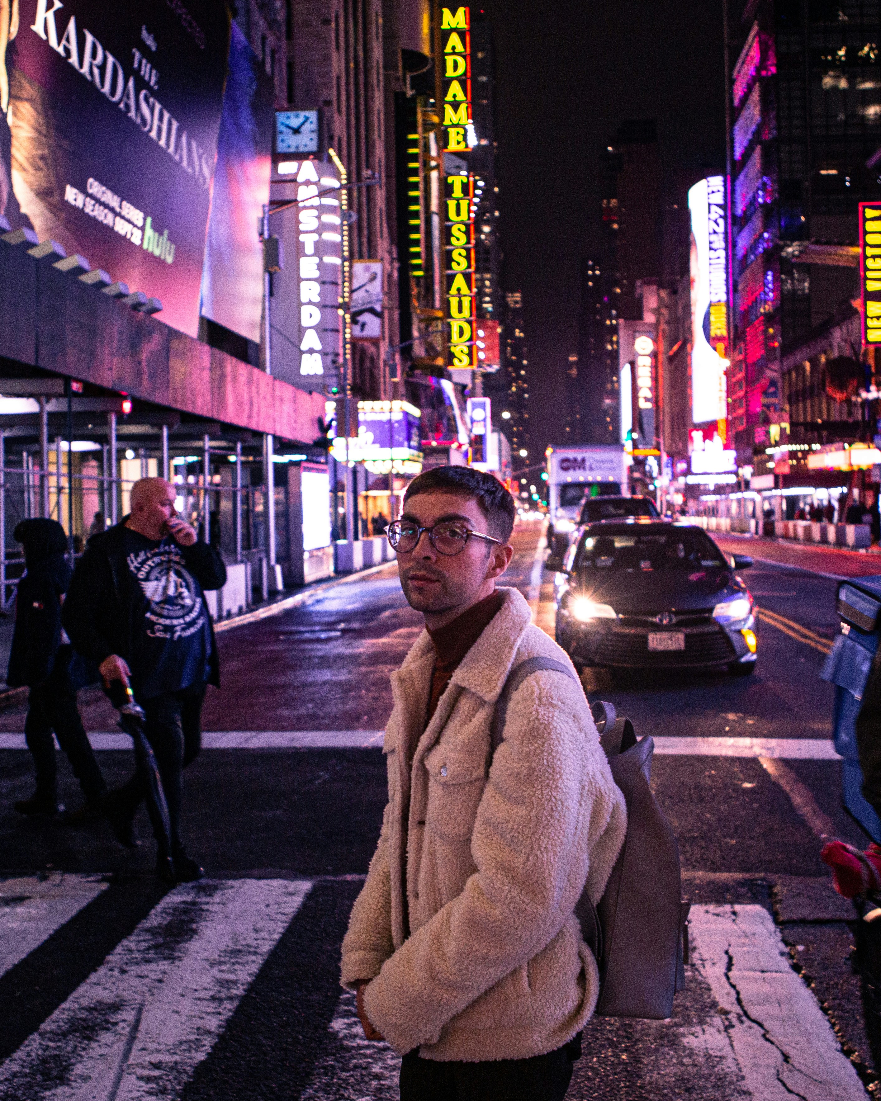 A man standing on the side of a street