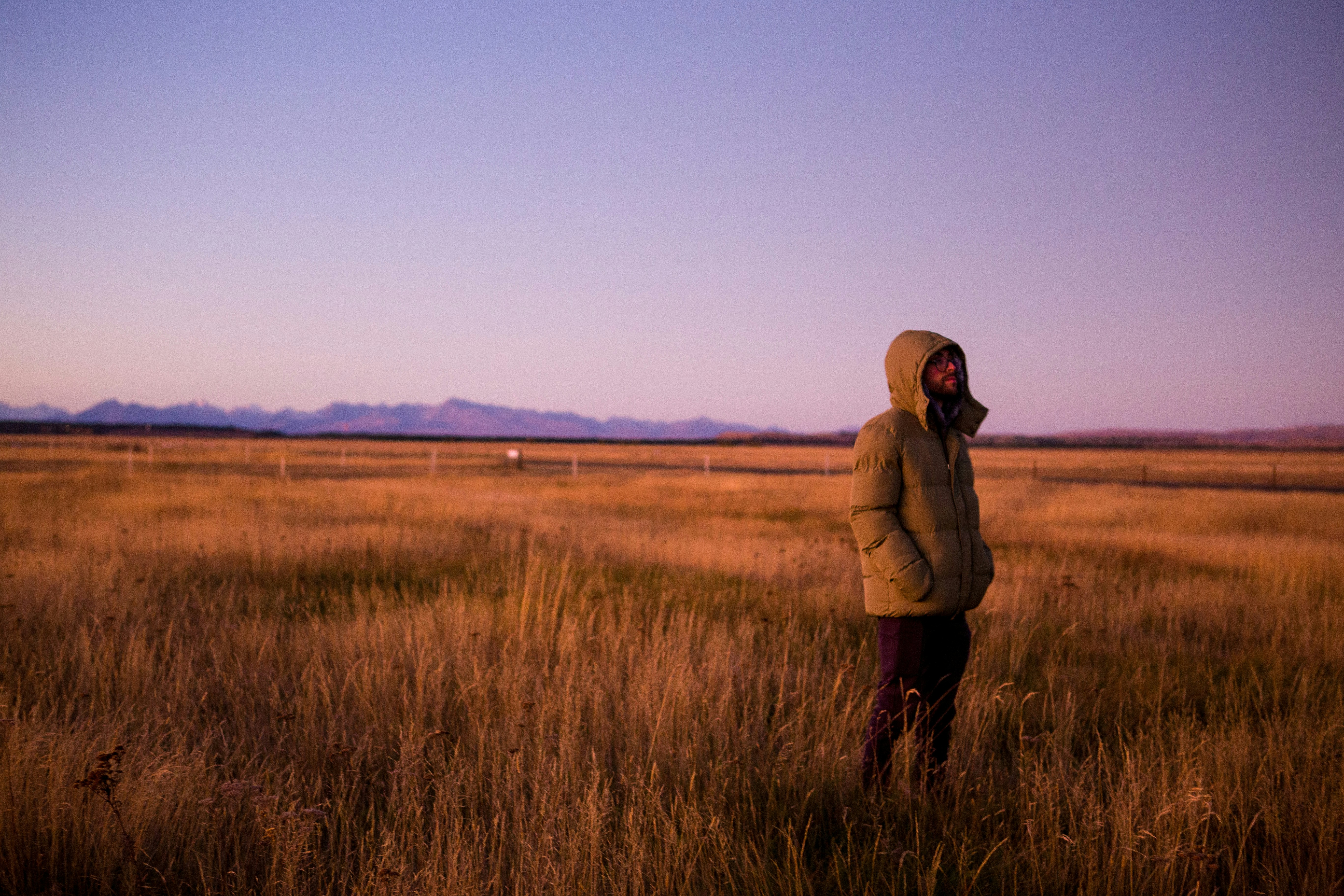 A person standing in a field of tall grass