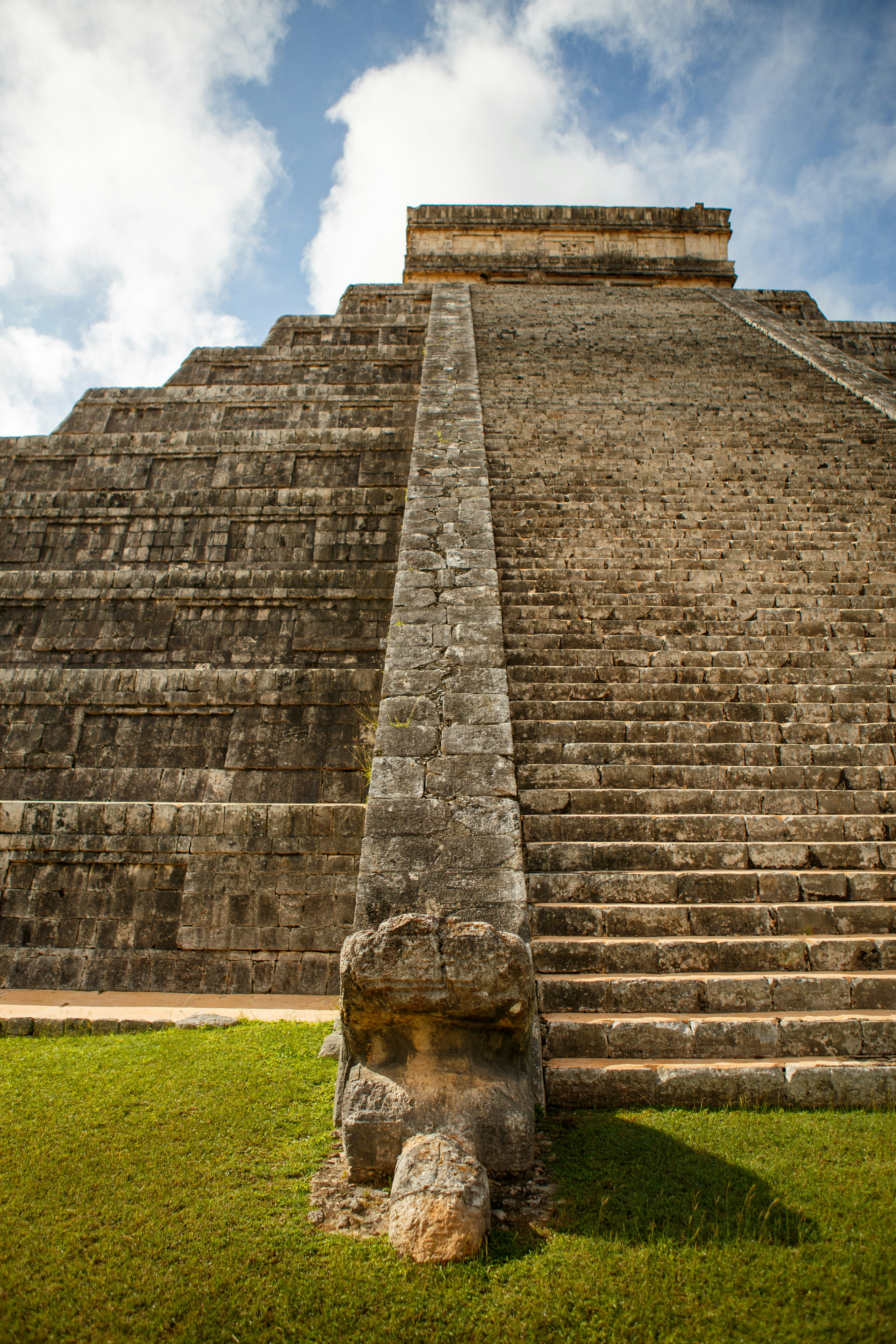 A large stone structure sitting on top of a lush green field