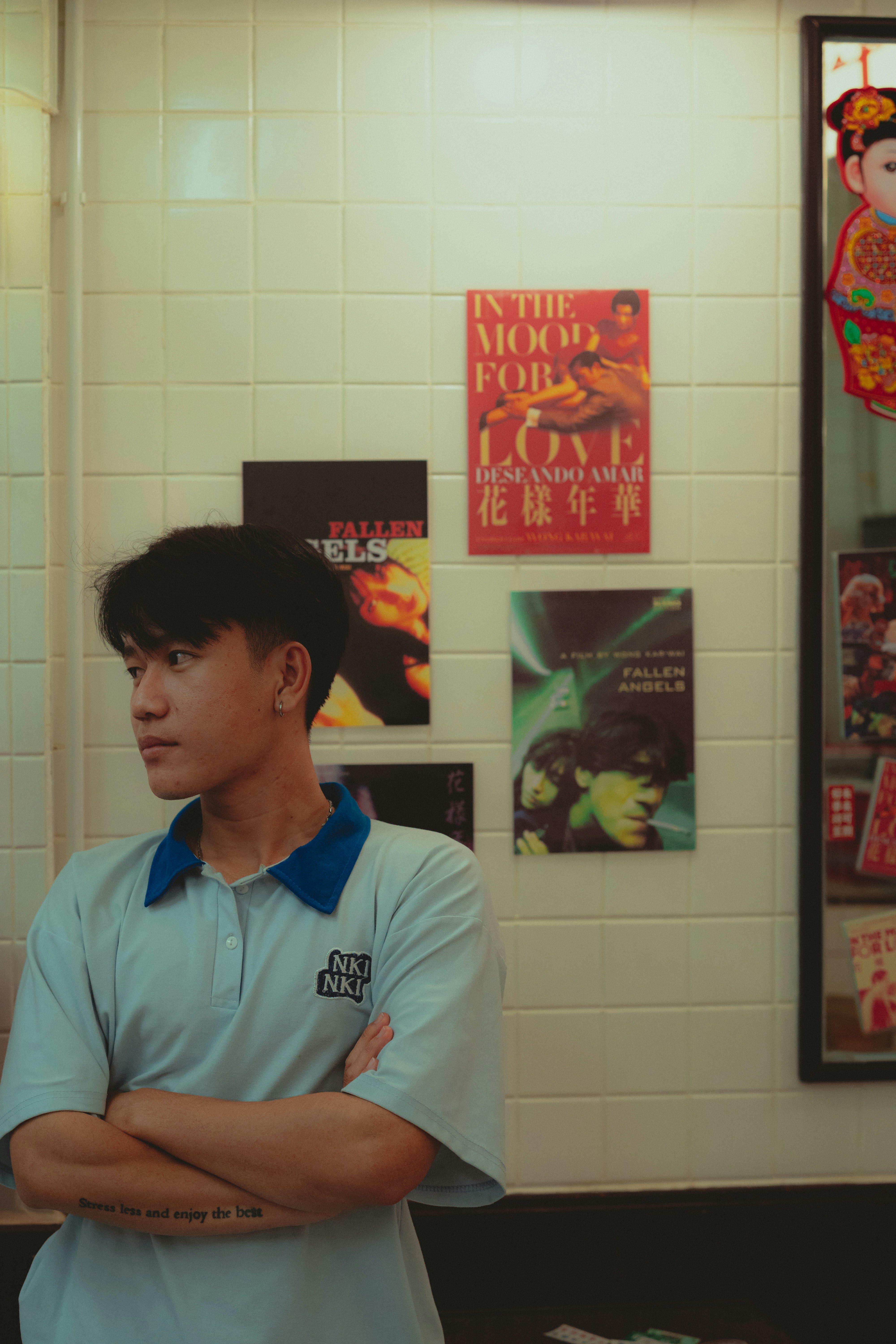 A man standing in a room with his arms crossed