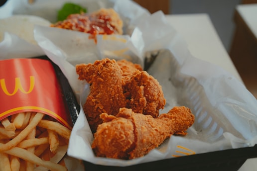 A box filled with fried chicken and french fries