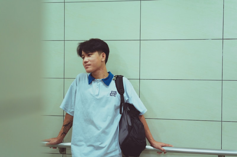 Young man by white wall