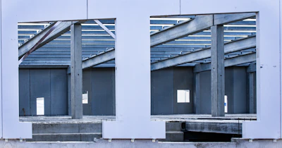 A large mirror reflecting a building's windows
