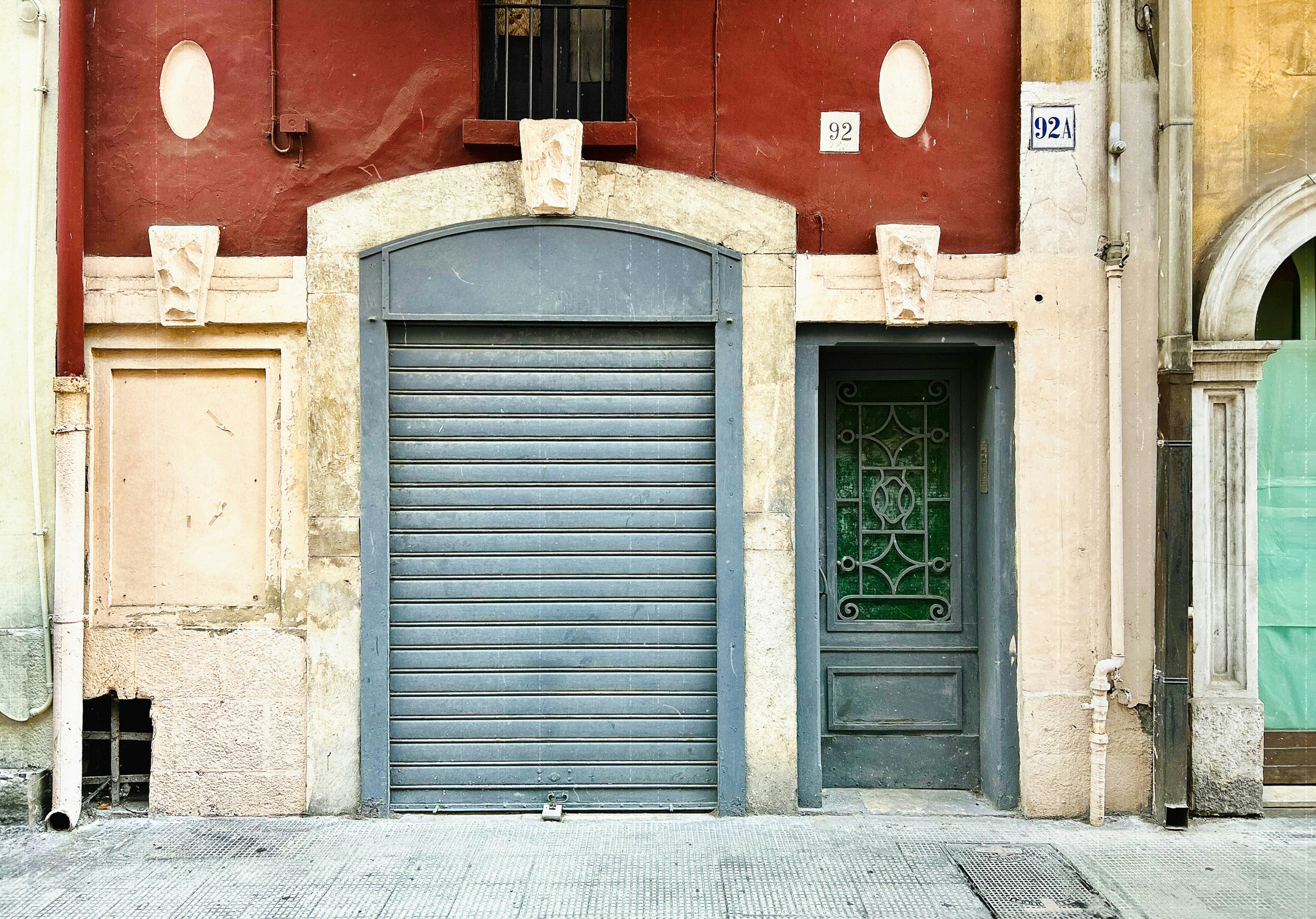 A building with a blue door and a green door