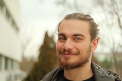 A man with a beard and a black shirt