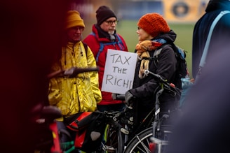 A person in a wheelchair holding a sign