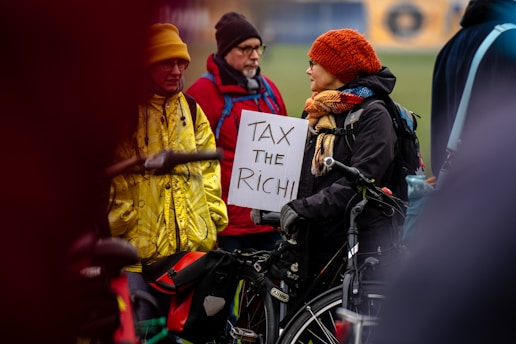 A person in a wheelchair holding a sign