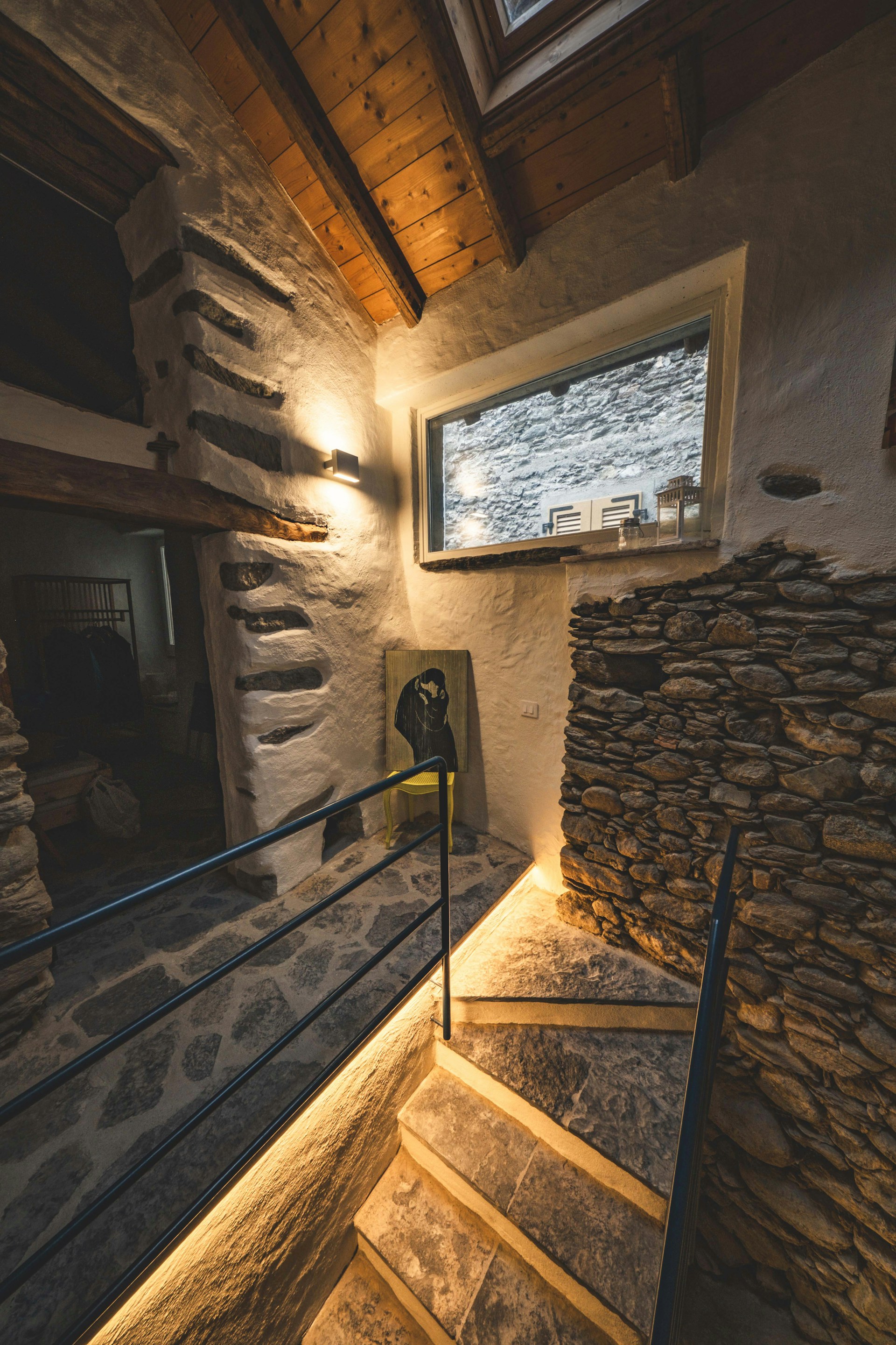 A stone building with a stair case and a window