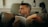 A man sitting on a couch reading a book