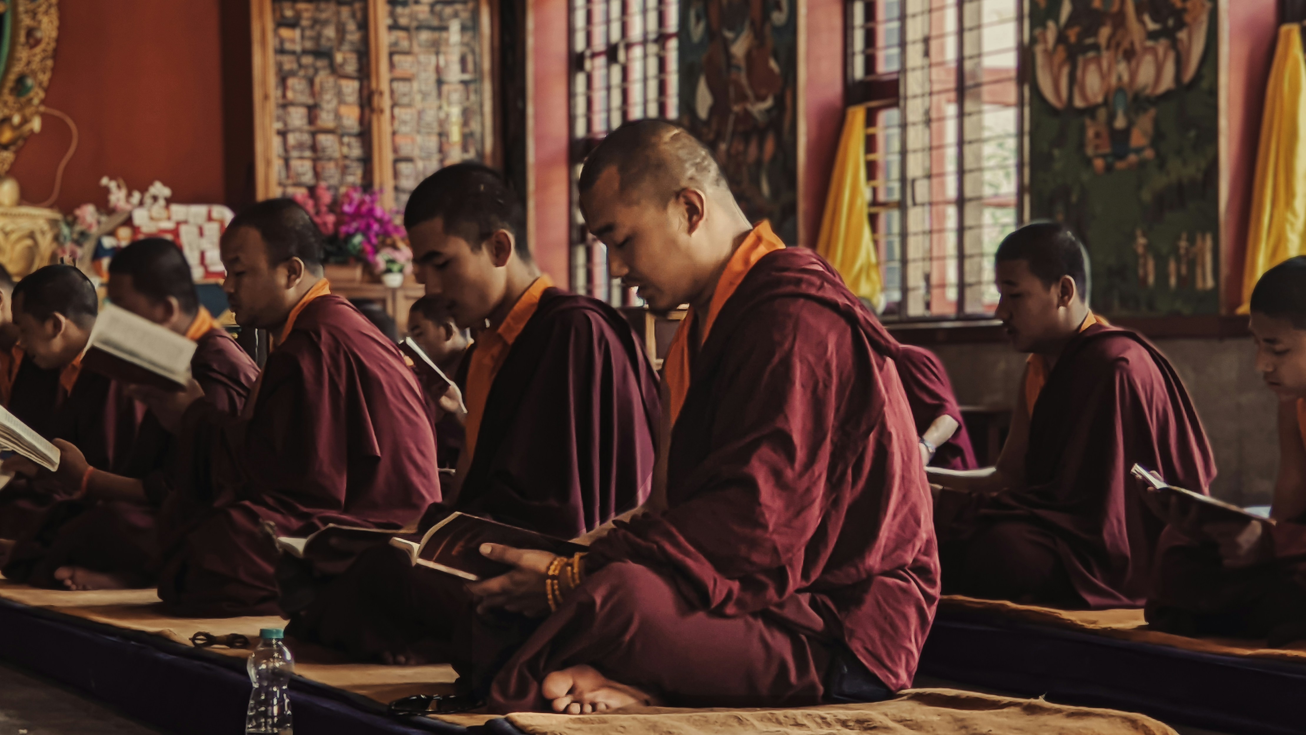 A group of monks sitting in a room