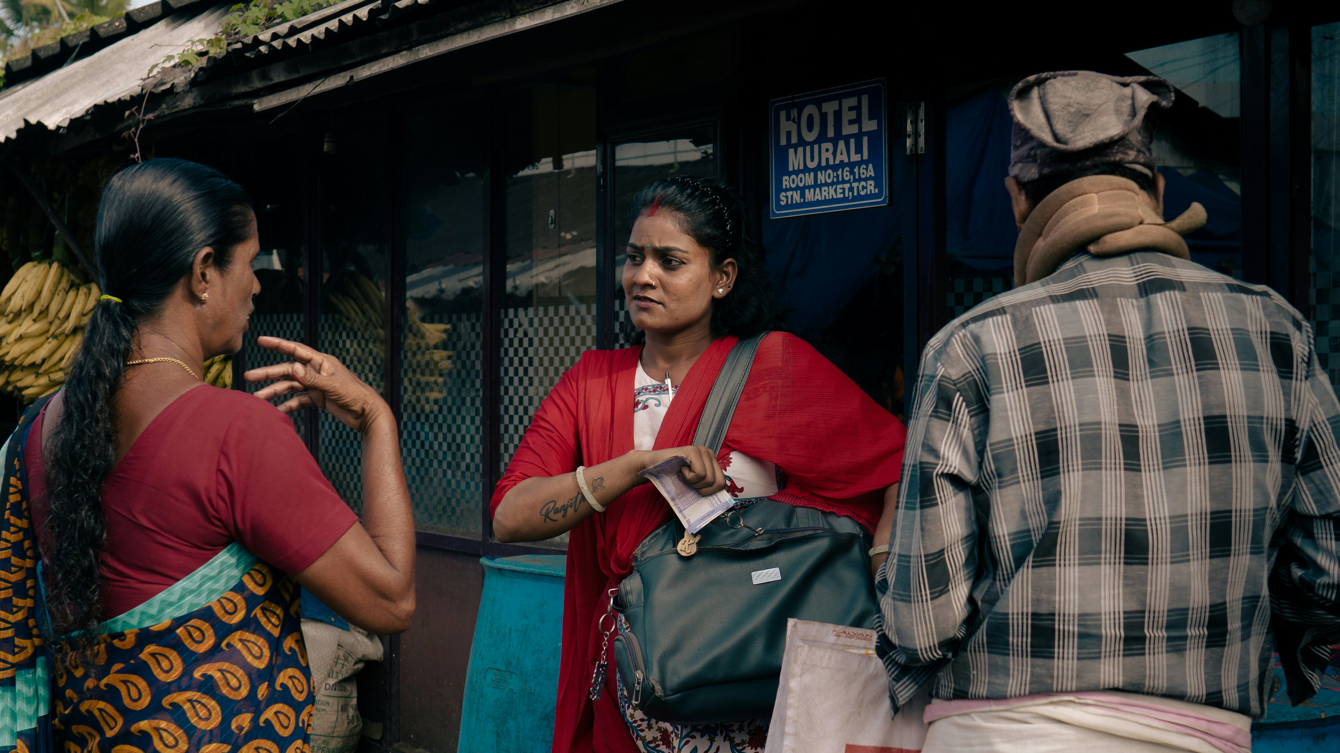 A group of young, diverse Kerala candidates, some holding job application forms, looking hopeful outside a PSC office.