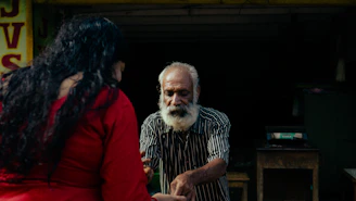 A man and a woman standing in front of a store