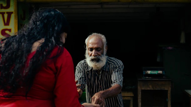 A man and a woman standing in front of a store