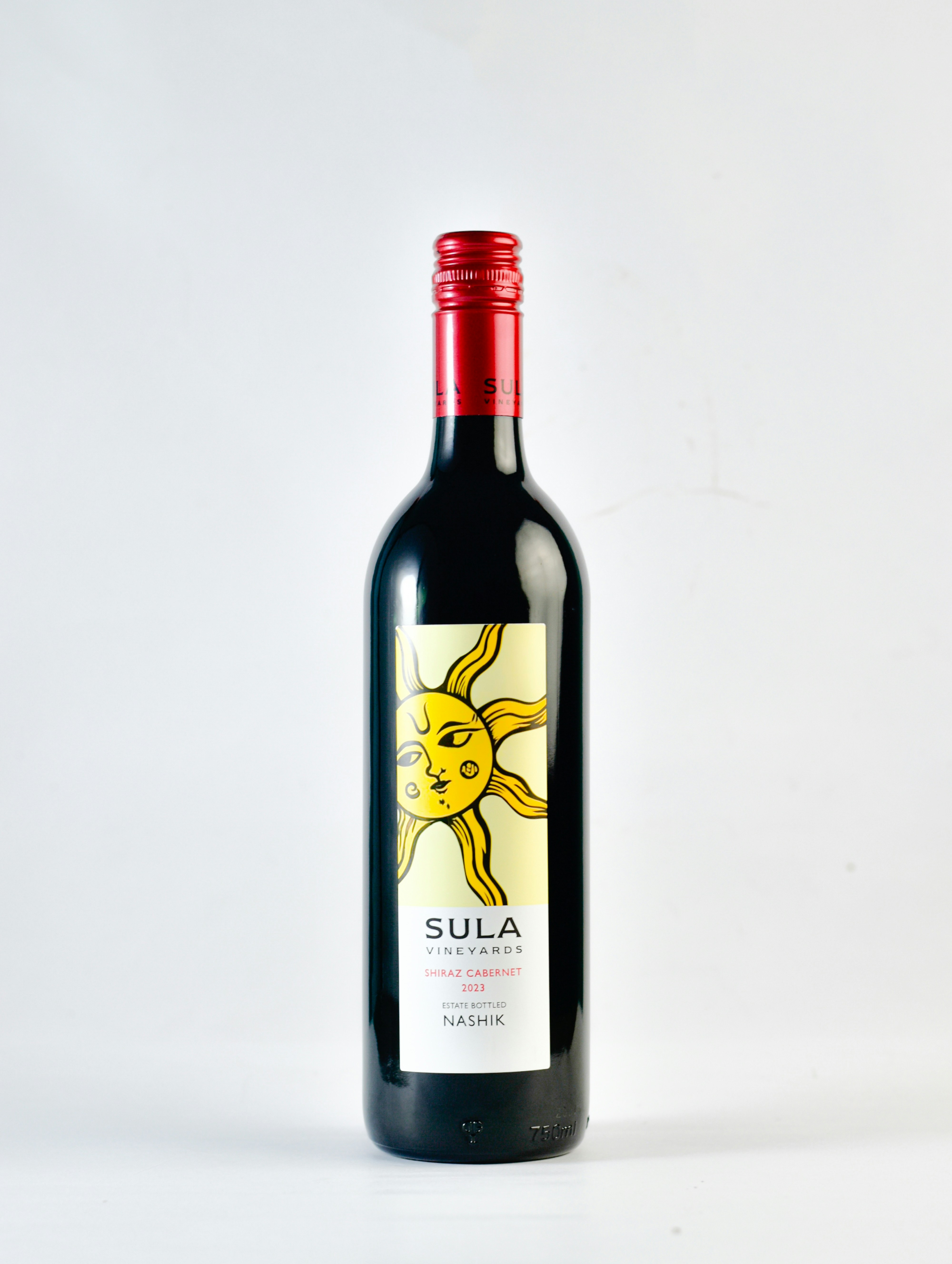 A bottle of red wine with a yellow sun on it