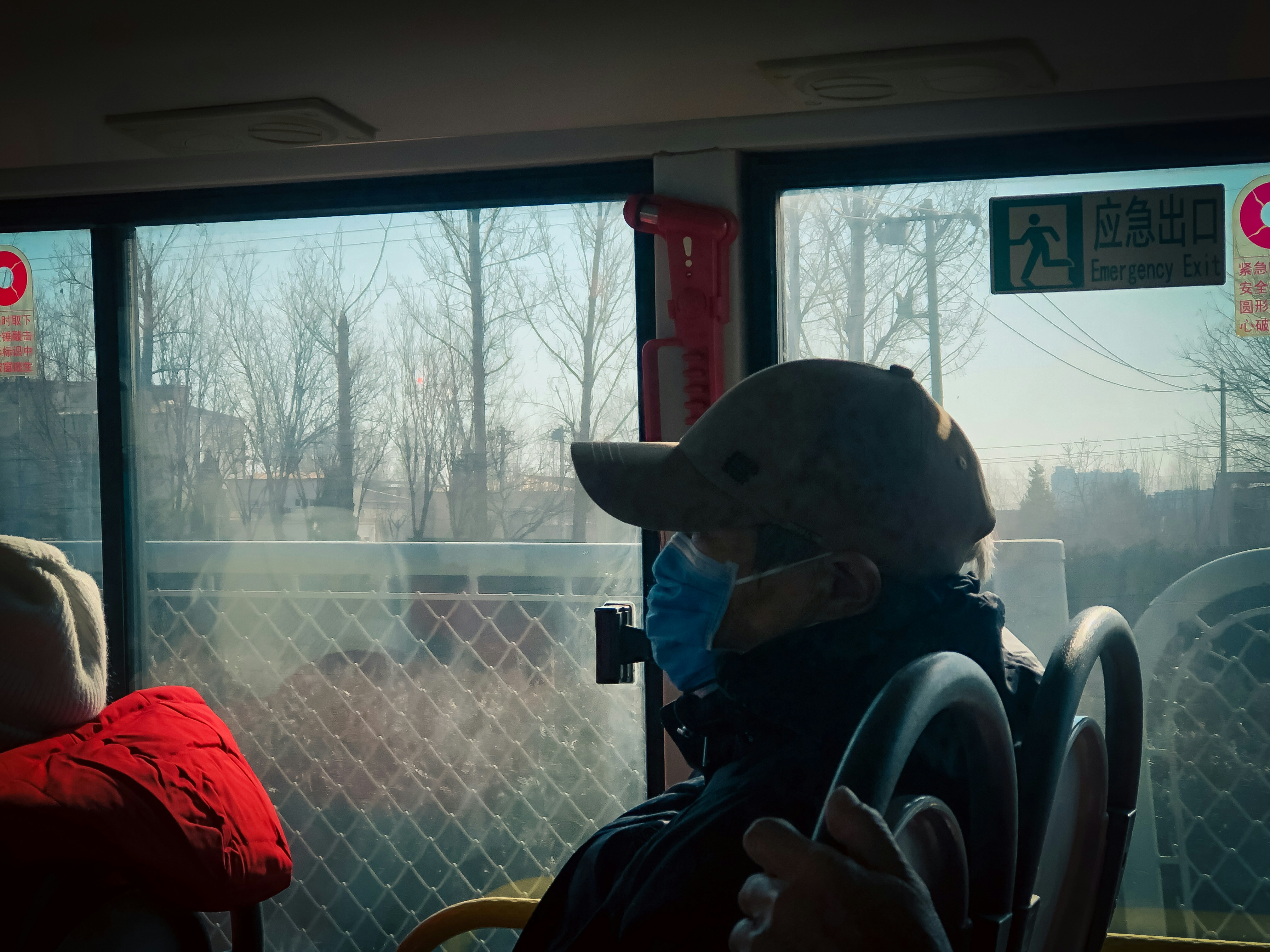 A person wearing a mask on a bus