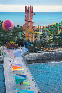 A pier with a bunch of colorful umbrellas on it