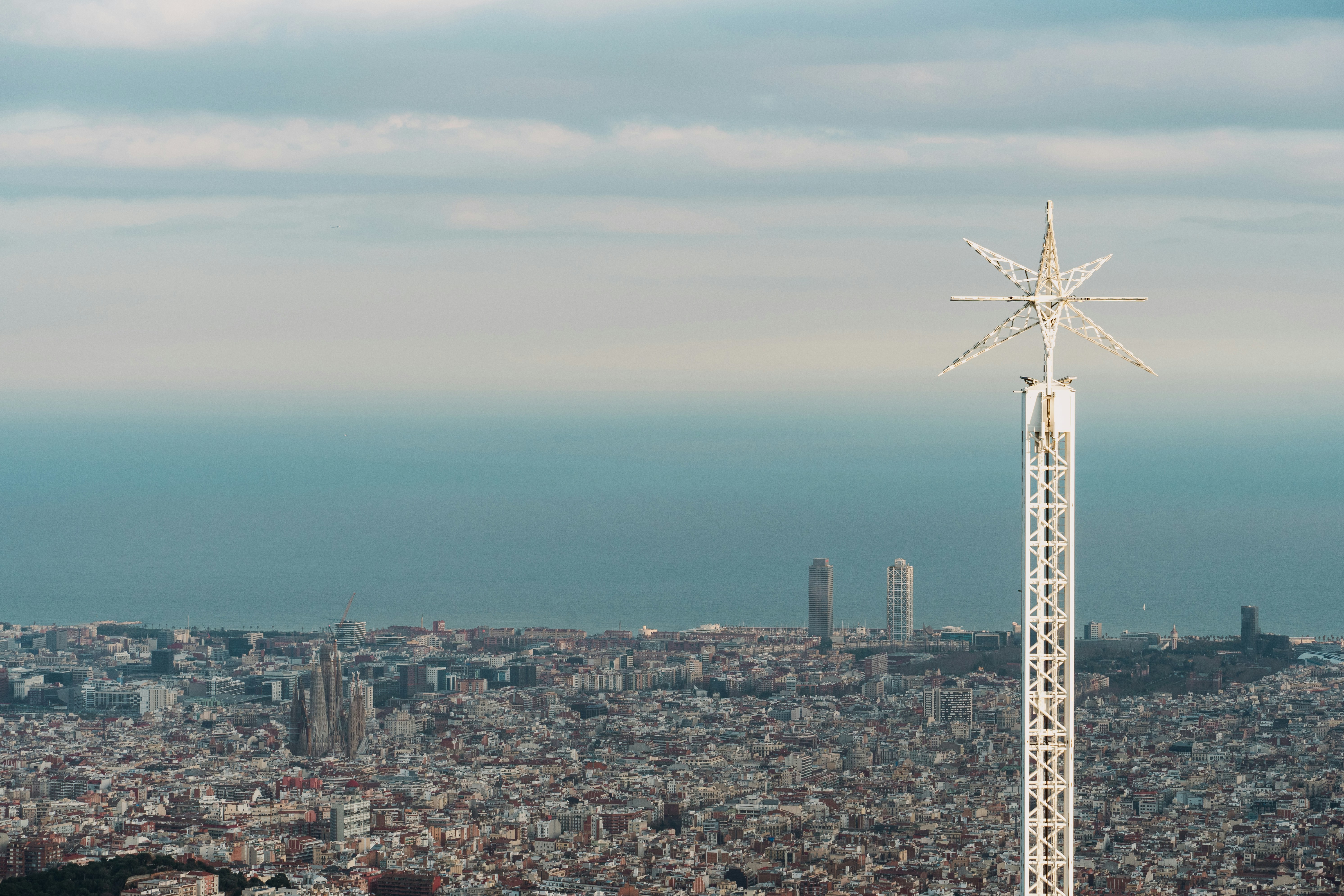 A view of a very tall building with a snowflake on top of it