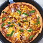 A pizza sitting on top of a pan covered in toppings