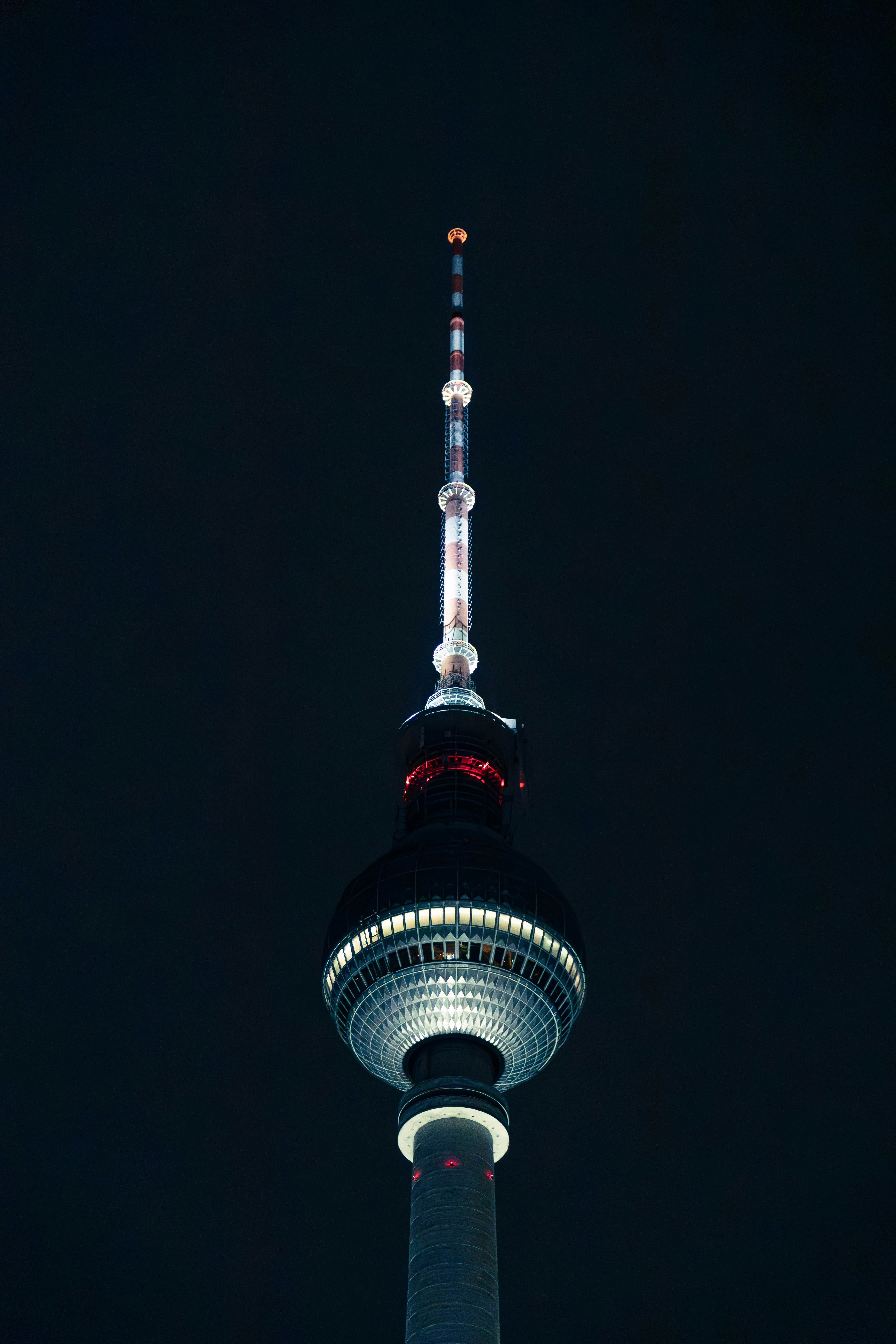 A very tall tower with a very bright light on top of it