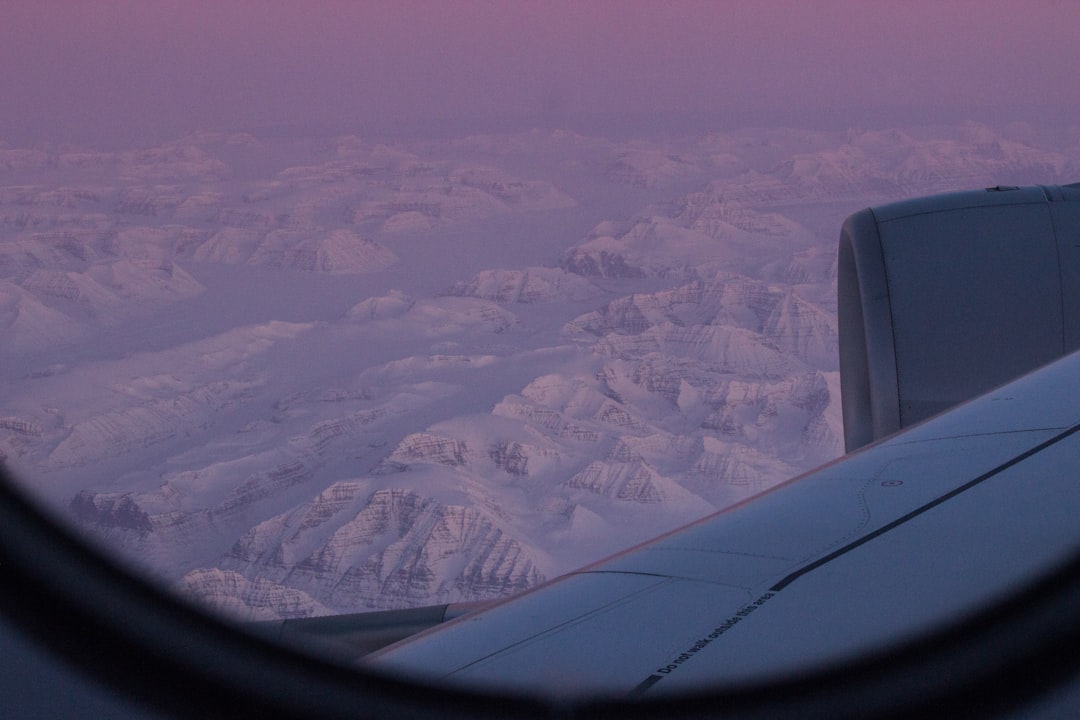 A view of the wing of an airplane in the sky,