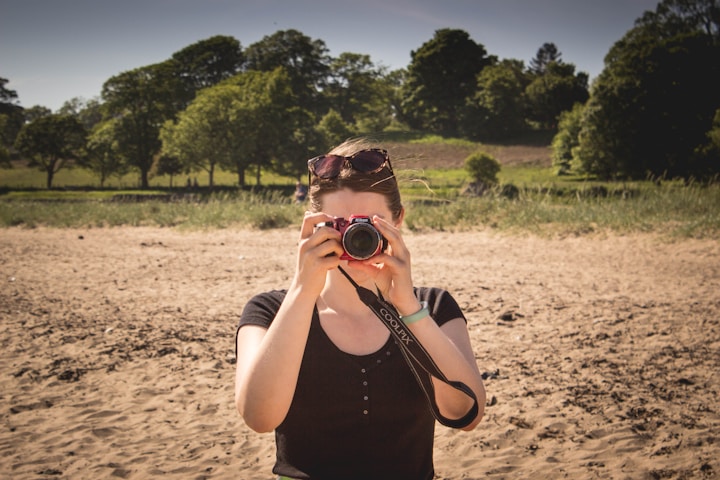 A woman taking a picture of herself with a camera