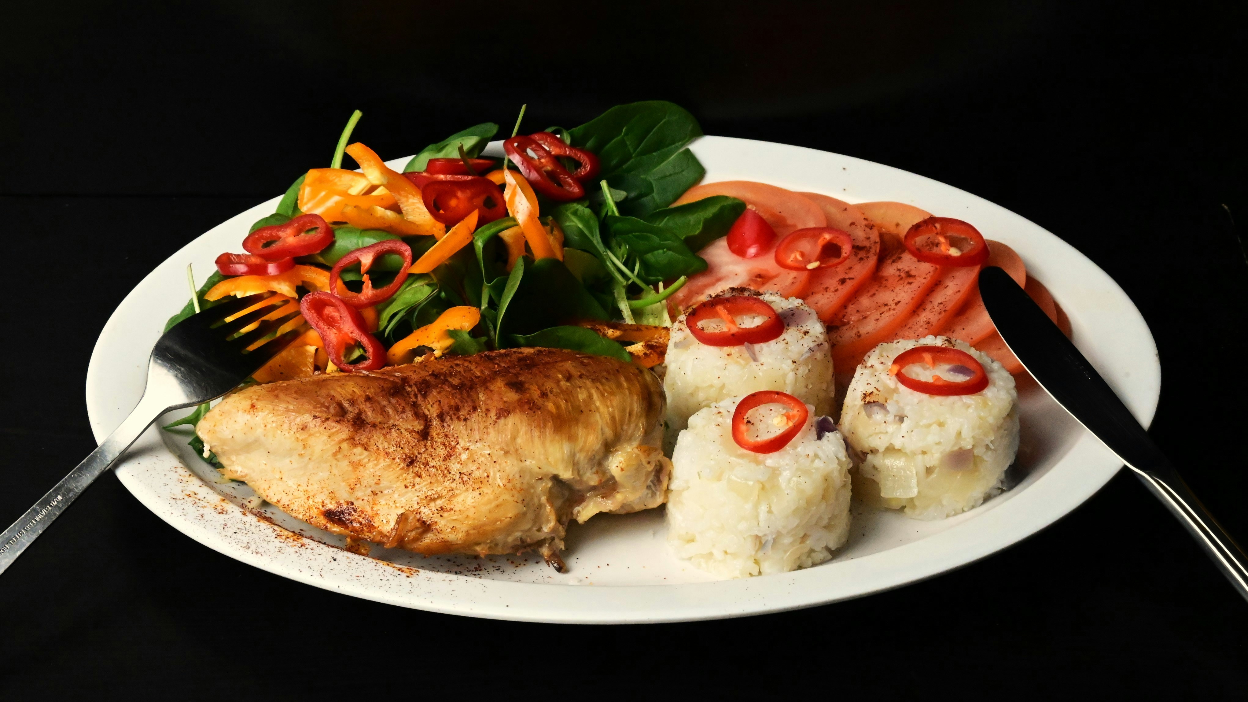 A white plate topped with meat and veggies