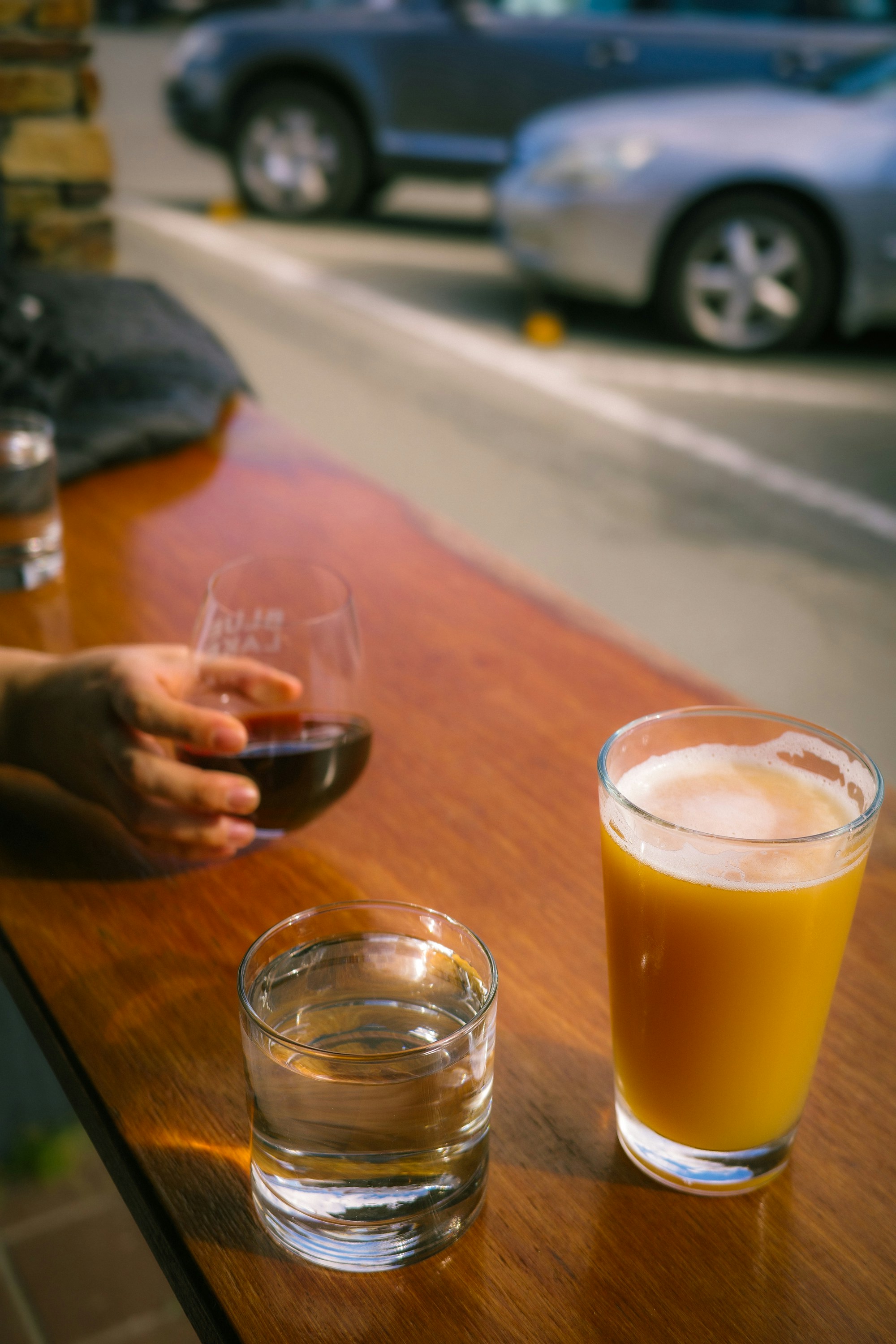 A person sitting at a table with a glass of orange juice