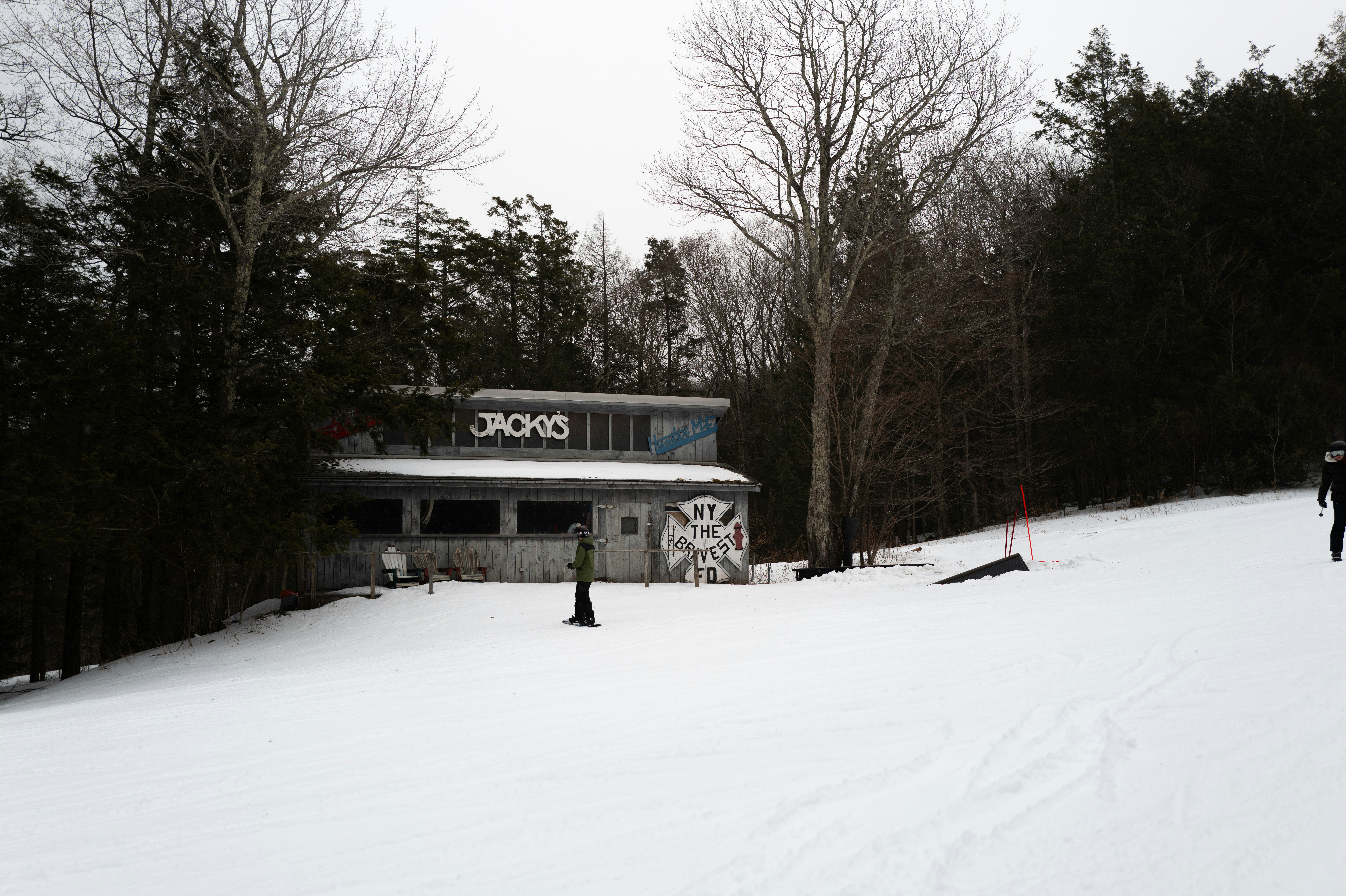A couple of people riding skis down a snow covered slope