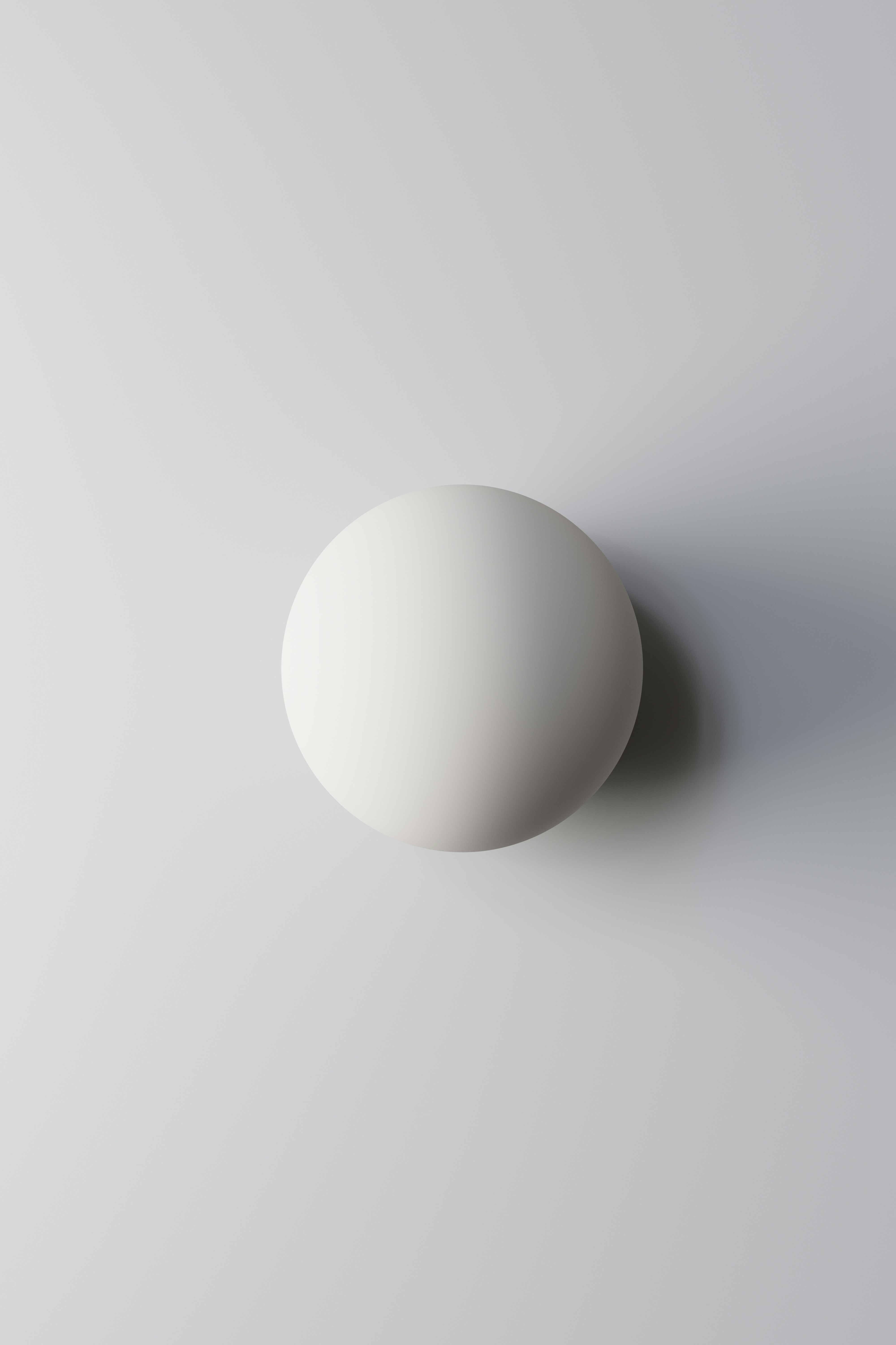 A white egg sitting on top of a white table