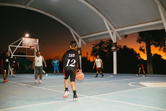 A group of young men playing a game of basketball