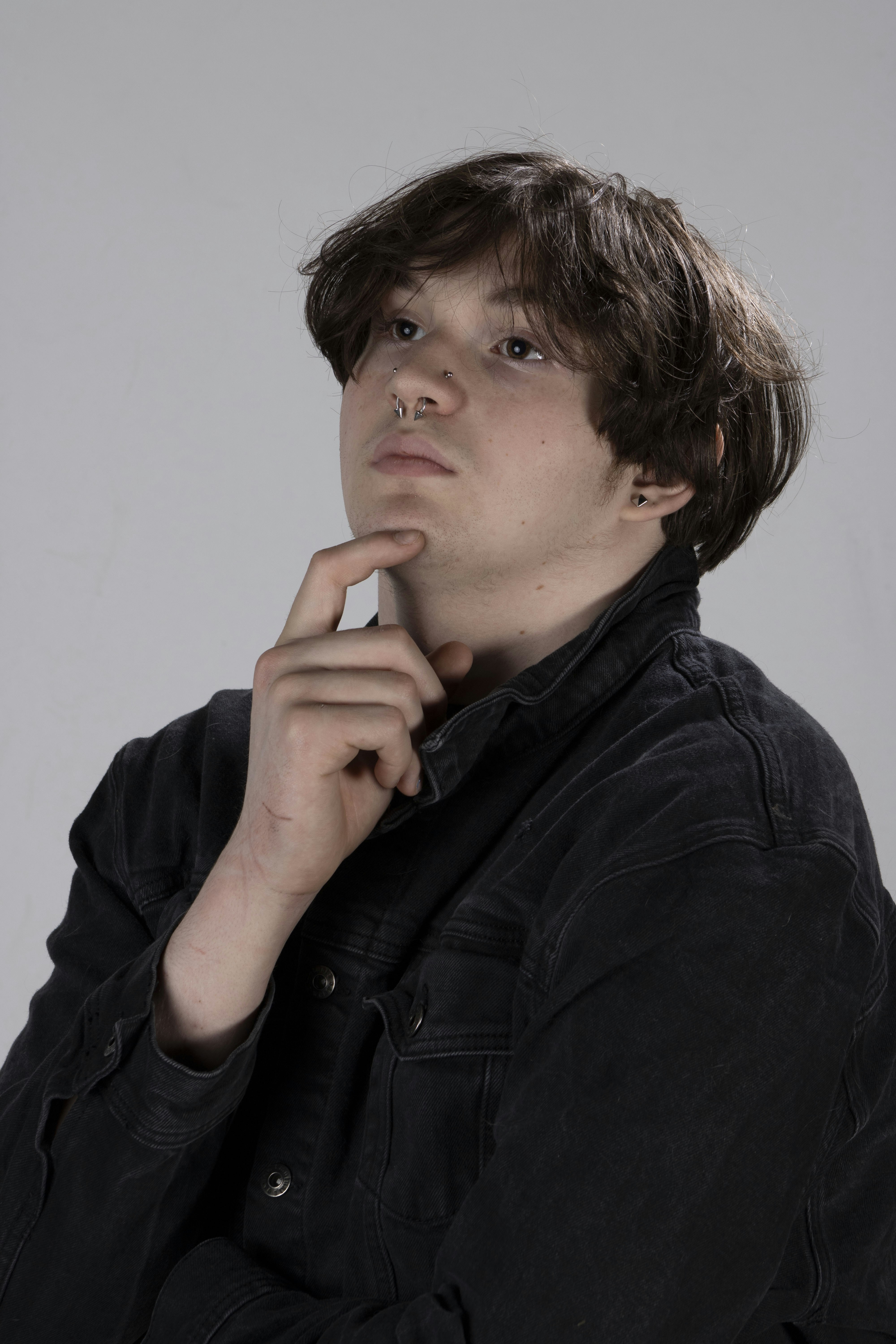 A young man is posing for a picture