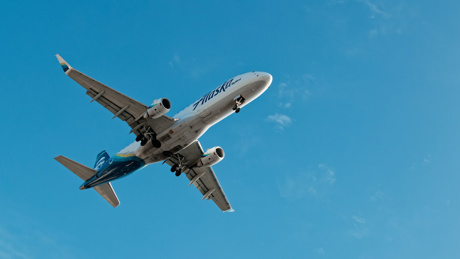 A large passenger jet flying through a blue sky