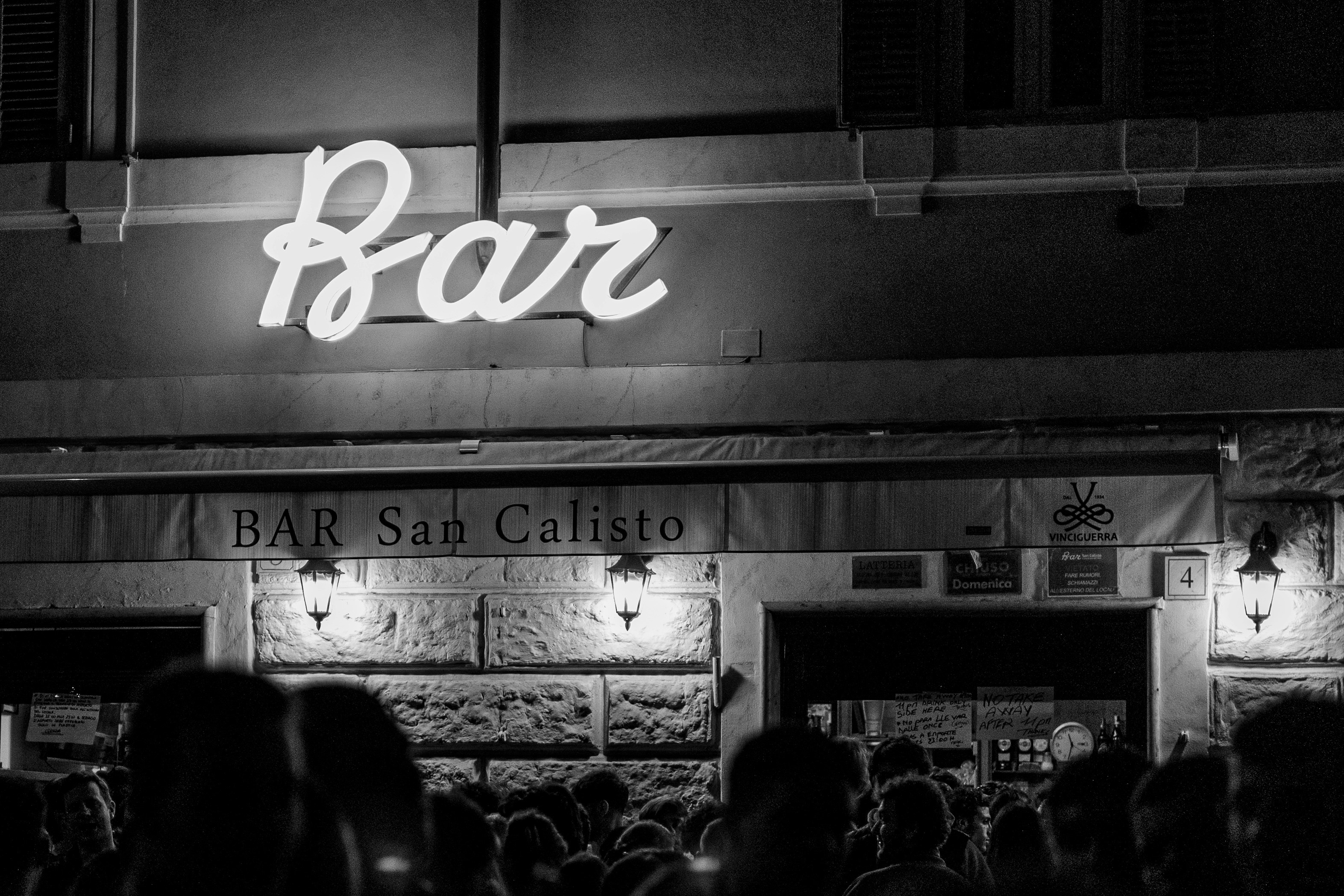 A crowd of people standing outside of a building