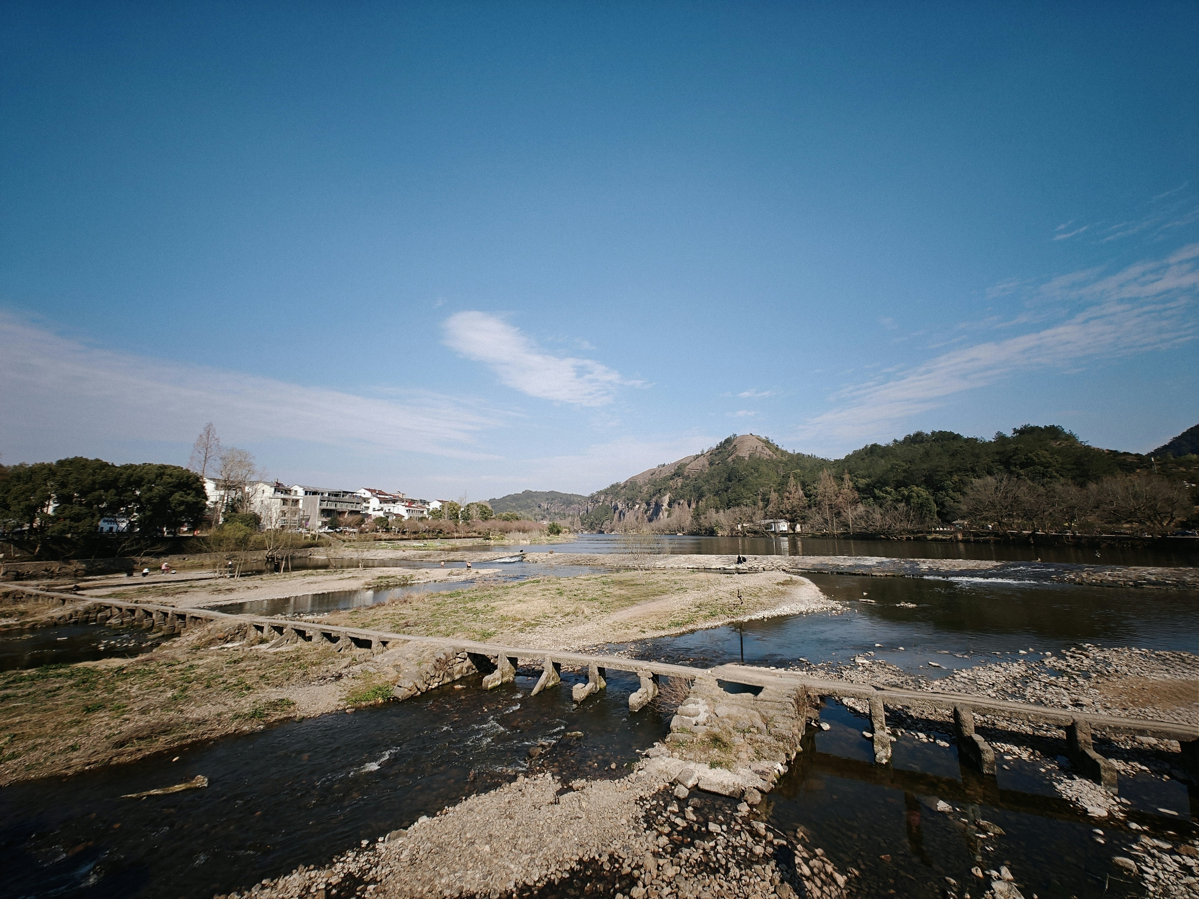 A view of a body of water with mountains in the background