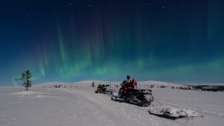 A person riding a snowmobile on a snowy surface