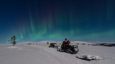 A person riding a snowmobile on a snowy surface