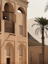 A tall building with a palm tree in front of it