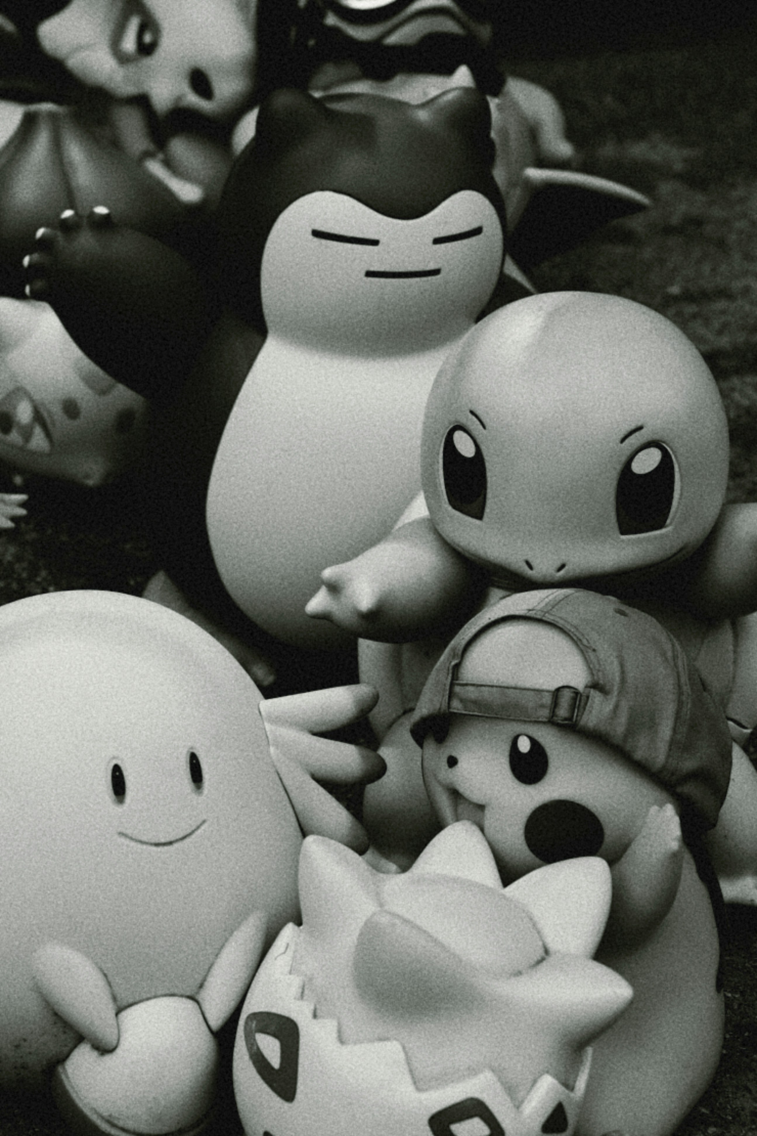 A black and white photo of a group of pokemon figurines