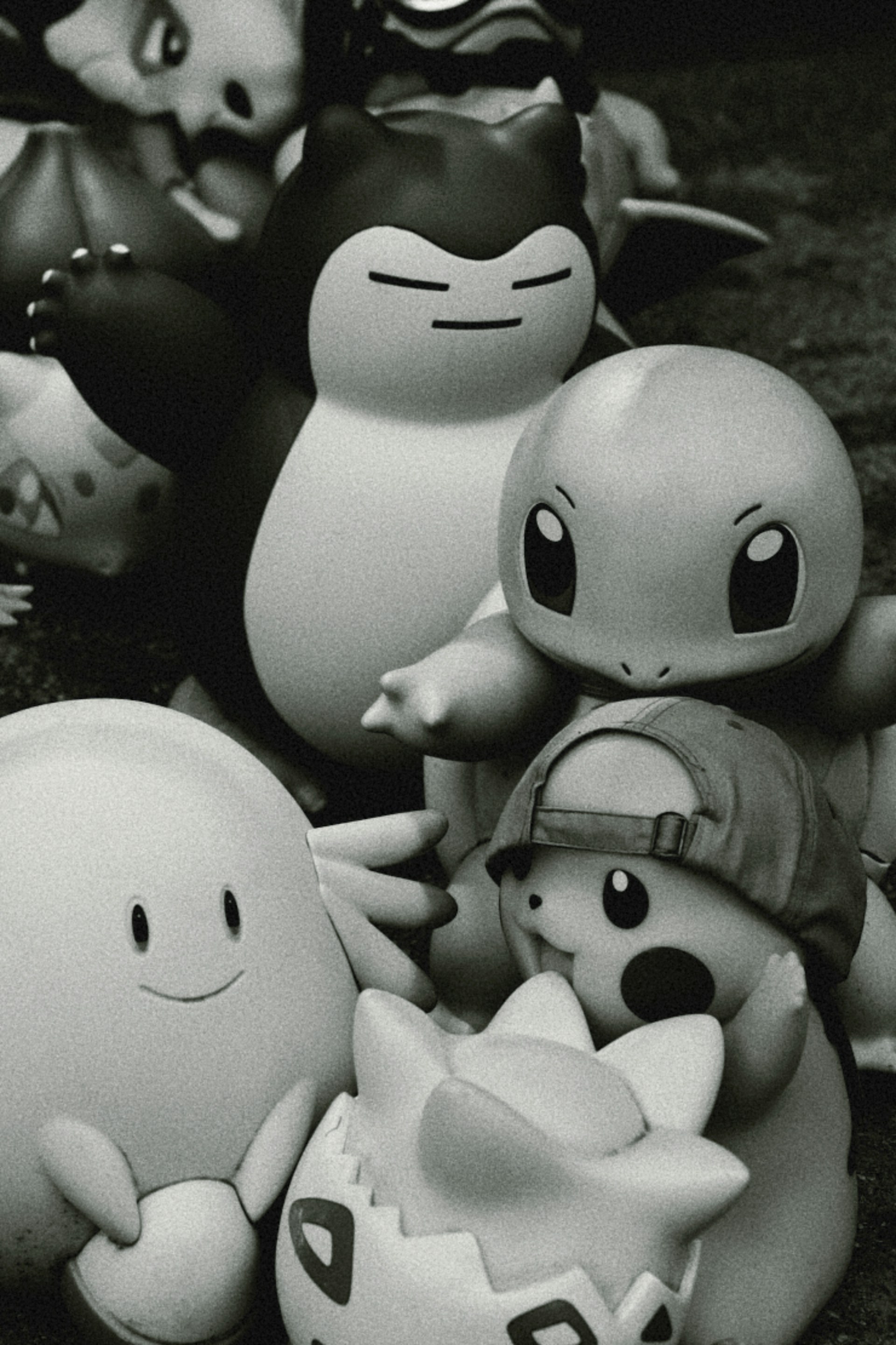 A black and white photo of a group of pokemon figurines