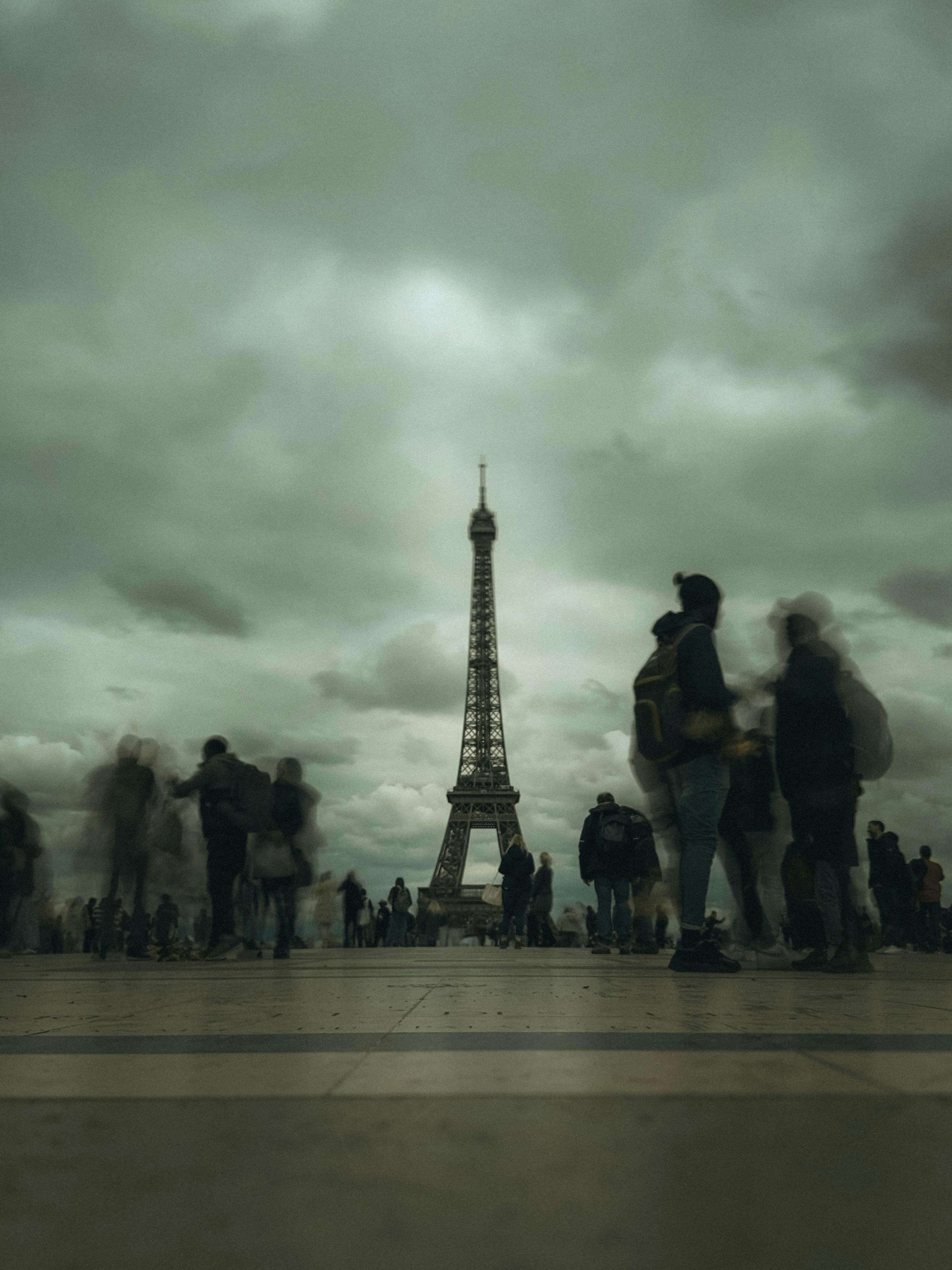 A group of people standing in front of the eiffel tower