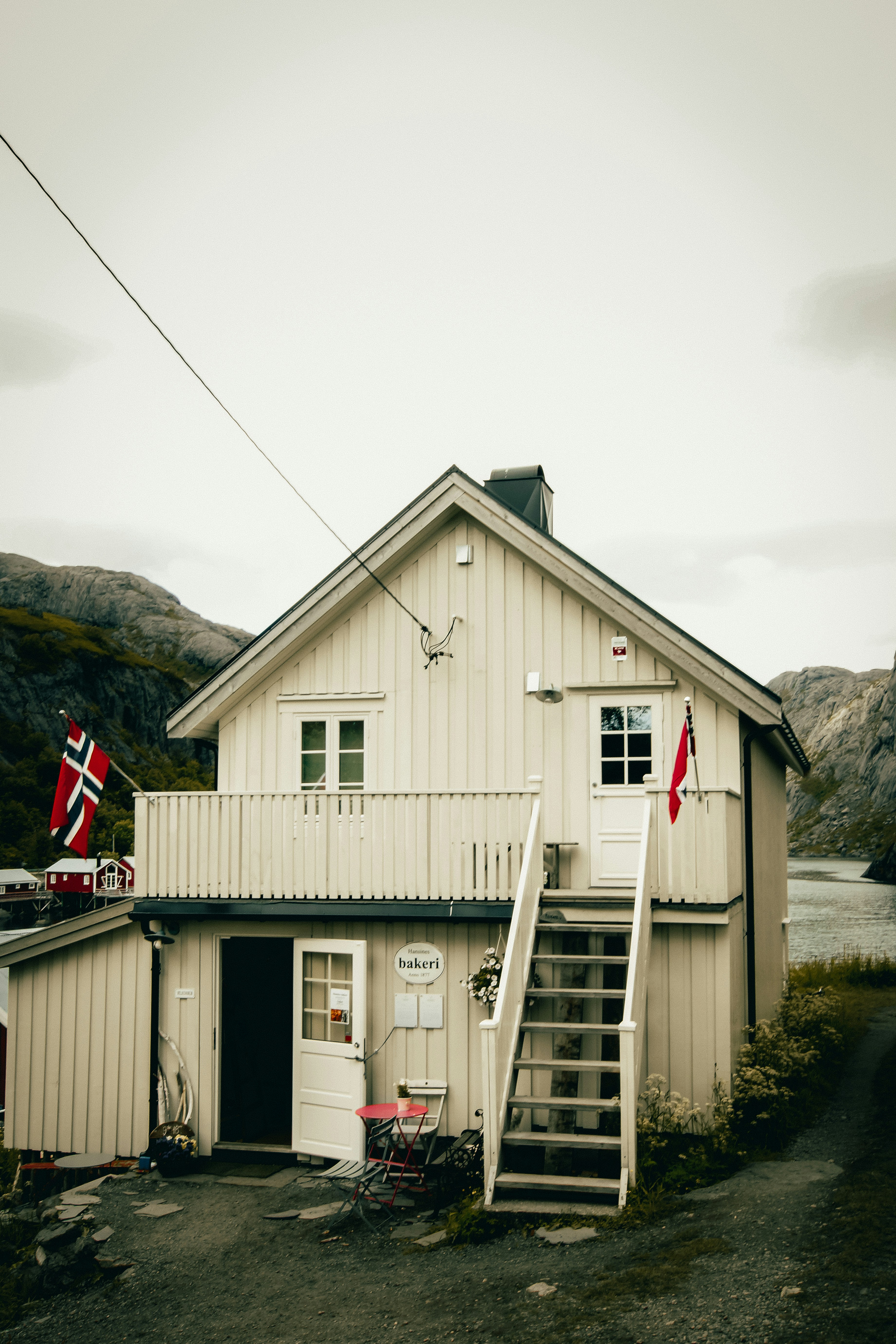 A white house with a red and white flag on it