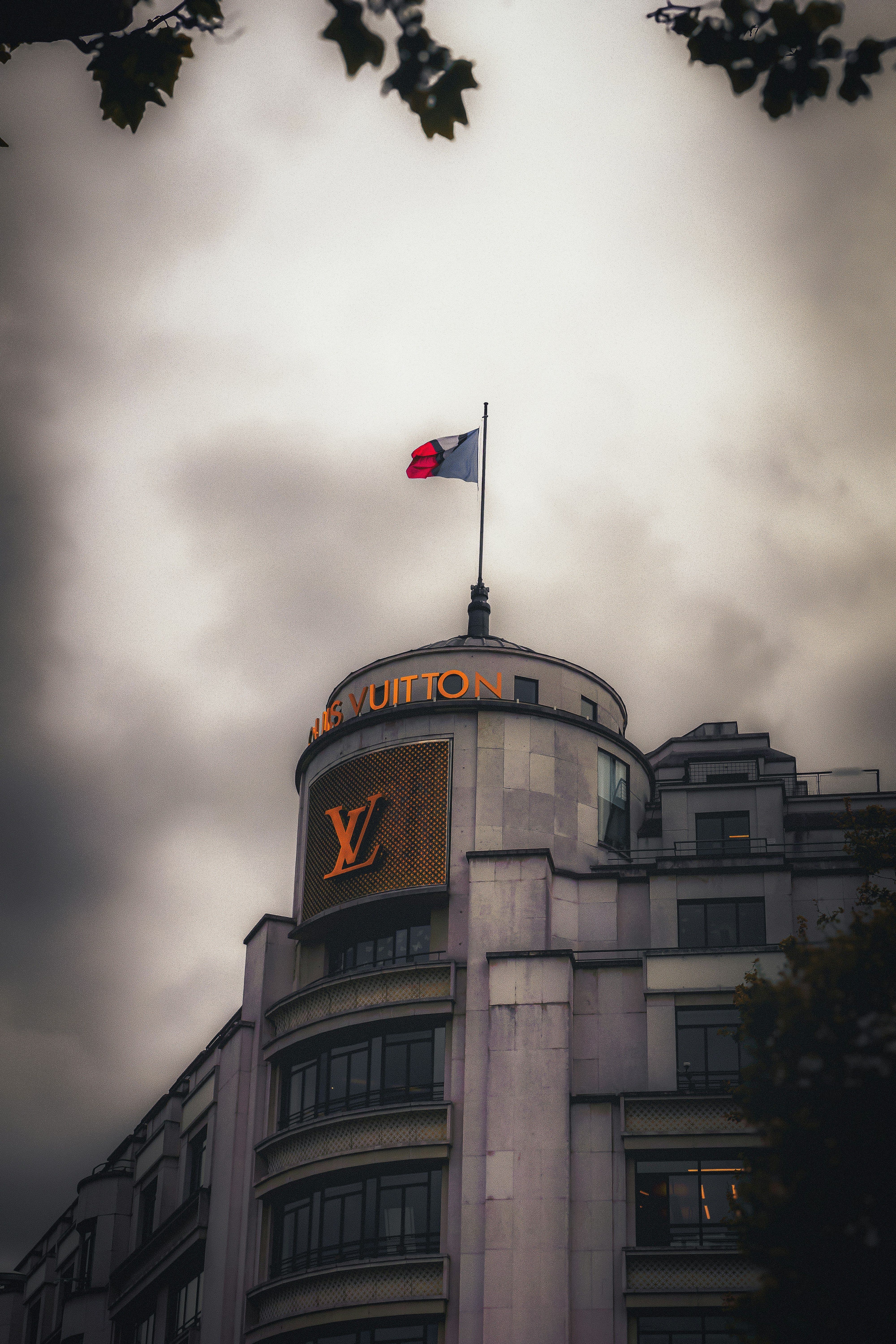 A very tall building with a flag on top