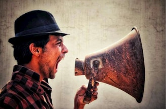 A man with a hat and a megaphone